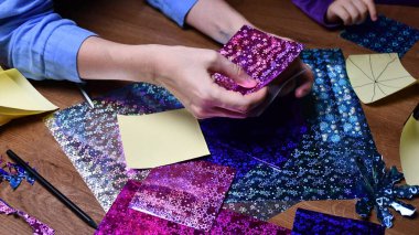 Anne ve çocuk hobi olarak parlak renkli kağıtlarla el sanatları yapıyor.