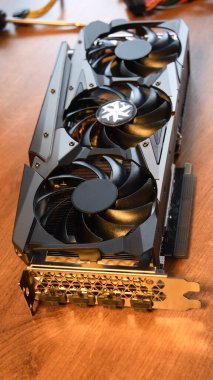 Brand new graphics card closeup atop wooden table