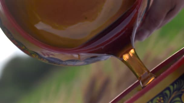 Pouring honey outdoors — Stock Video