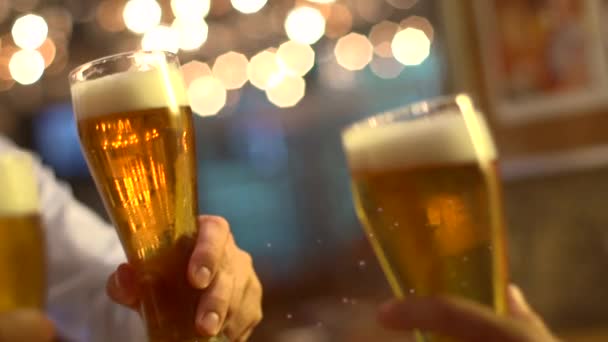 Friends clink glasses of beer at a bar — Stock Video