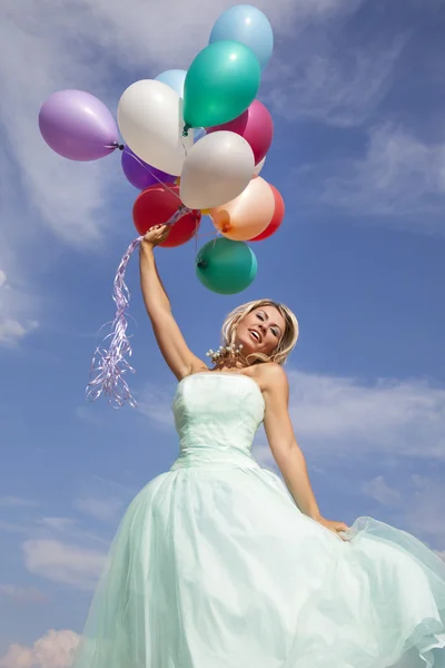 Beautiful, happy woman dancing with balloons — Stock Photo, Image