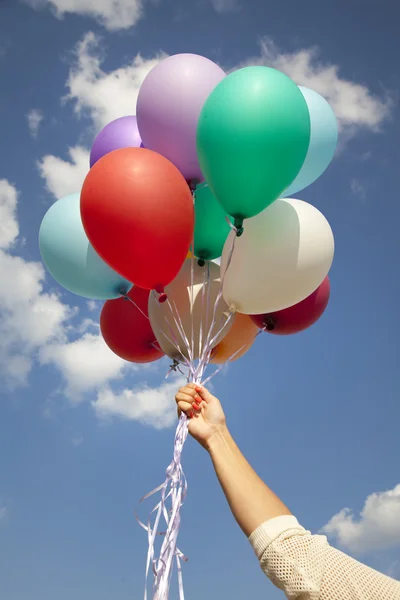 Kadın el ile renkli balonlar — Stok fotoğraf