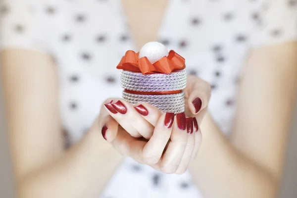 Beautiful woman hands holding christmas decorations — Stock Photo, Image