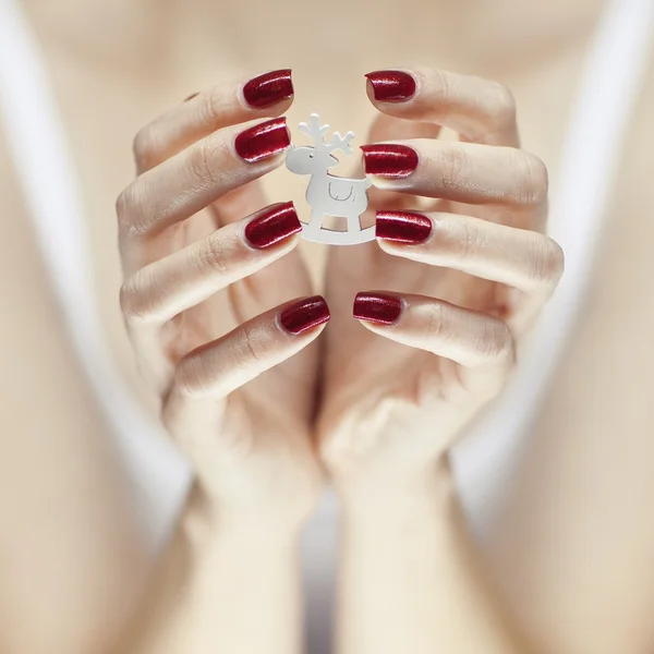 Beautiful woman hands holding christmas decorations — Stock Photo, Image