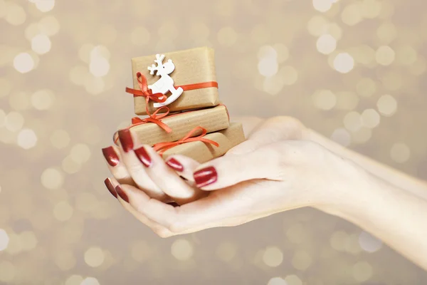 Beautiful woman hands holding christmas decorations — Stock Photo, Image