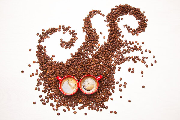 Coffee monster, coffee beans and 2 cups of espresso