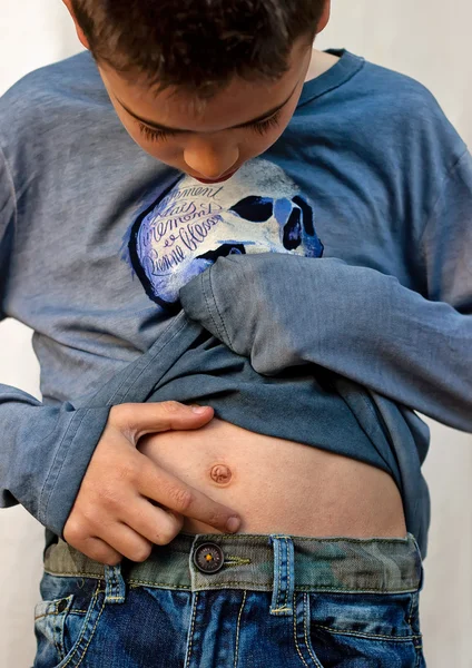 Boy looking at his belly button Stock Image