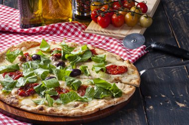 Mozzarella, kurutulmuş domates ve roka soslu Brezilya usulü pizza..
