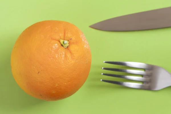 Orange on a green countertop — Stock Photo, Image