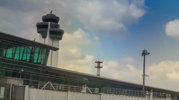 Control tower by airport terminal — Stock Video