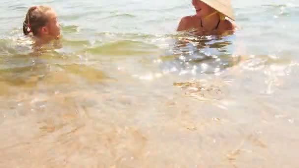 Girl walks out of transparent sea — Stock Video