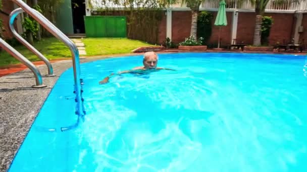 Man Swims along Swimming Pool — Stock Video