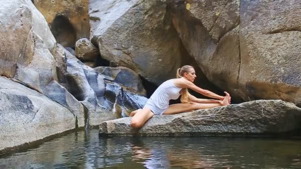 Girl Practicing Yoga near waterfall — Stock Video