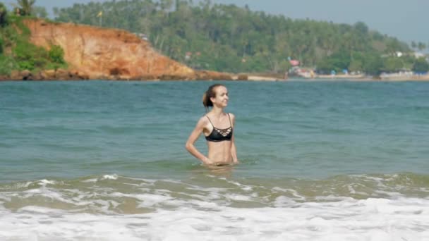 Femme avec un chignon à cheveux aime nager dans la mer tropicale lumineuse — Video