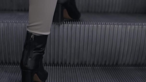 Young woman in black leather high heeled winter shoes — Stock Video