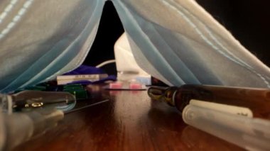 Kahverengi ahşap masada çeşitli covid tedavi araçları yatıyor