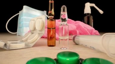 Aşı şişelerinin yanında şırınga ile tek kullanımlık maske ve eldivenler.