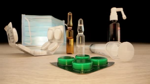 Vaccines surrounded by pills syringe syrup and face mask — Stock Video