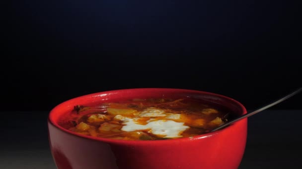 Sopa de colonos con crema agria blanca gira en tazón rojo — Vídeos de Stock