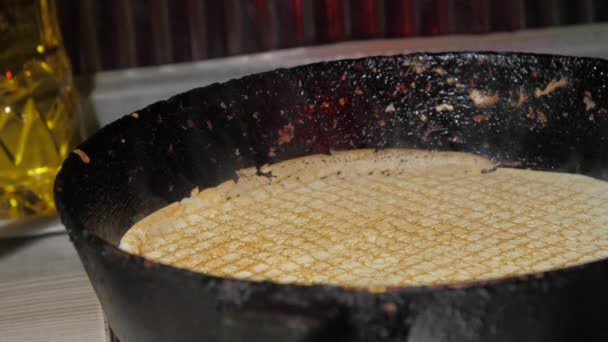 Yellow pancake lies hot frying pan surface and grey steam — Stock Video