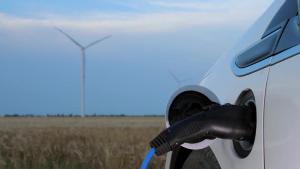 Turbina wiatrowa ładuje elektryczne samochody i stacje oraz generatory — Wideo stockowe