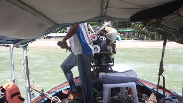 Mann steuert Boot in den Tropen — Stockvideo