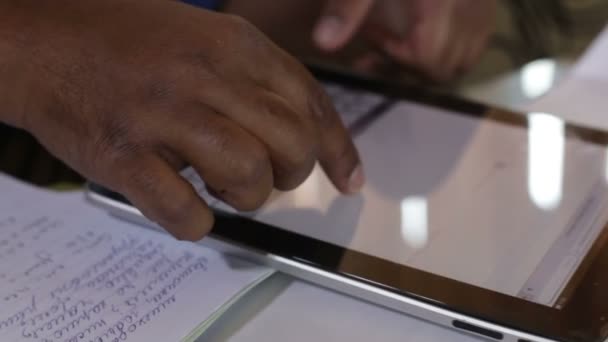 Man typing on tablet while sitting on sofa — Stock Video