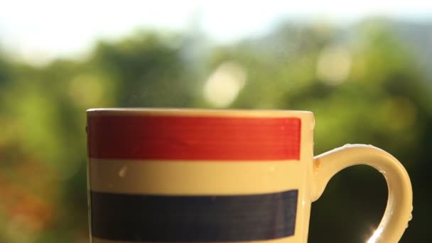 Striped cup with coffee — Stock Video