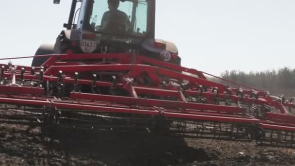 Tractor plowing black field — Stock Video