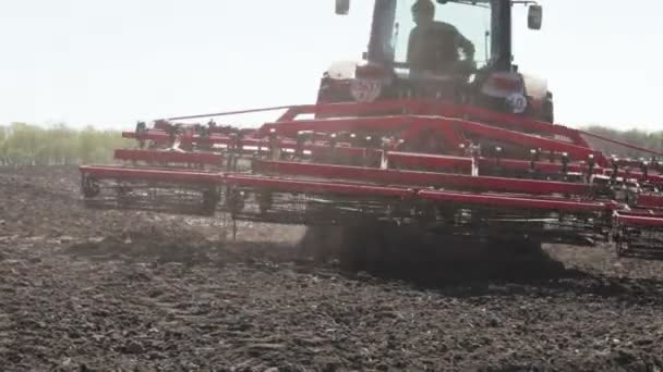 Tractor plowing black field — Stock Video