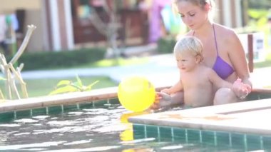 Anne ve kızı yüzme havuzunda oynamak