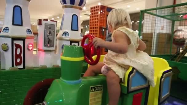 Little girl in toy train — Stock Video