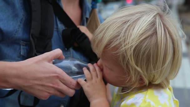 Little blonde child drinking water — Stock Video