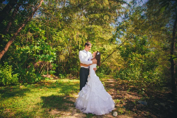 Bride and groom in tropical jungle — Stock Photo, Image