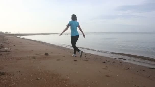 Dziewczyna, skakanie, chodzenie na plaży — Wideo stockowe