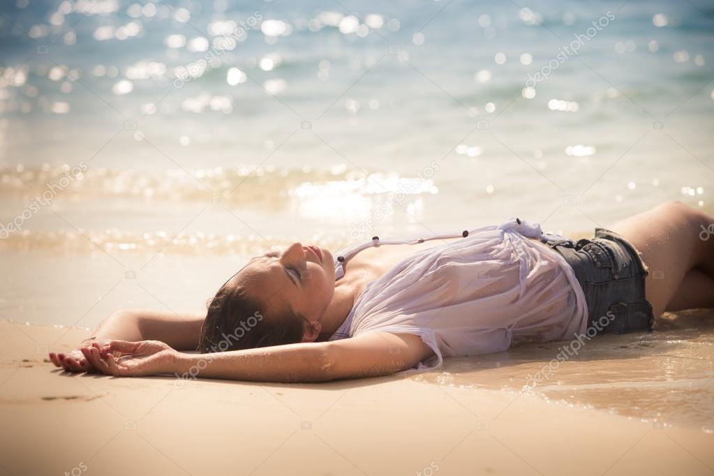 1023px x 682px - Sexy girl laying on sea beach Stock Photo by Â©slavastock 72649687
