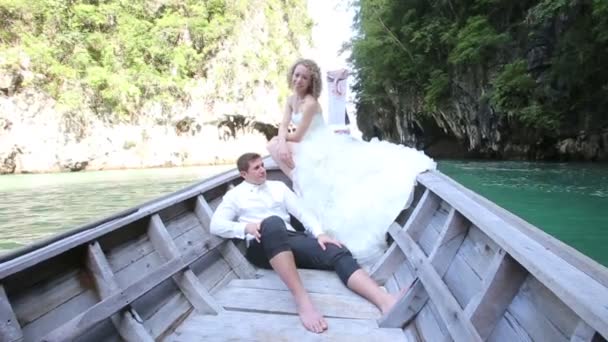 Bride and groom on sea in boat — Stock Video
