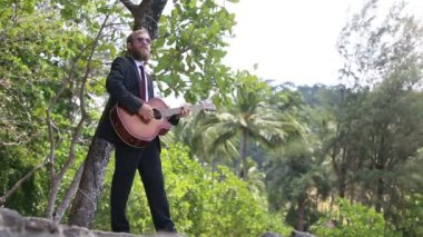 gitarist siyah gitar çalıyor ve şarkı söylüyor