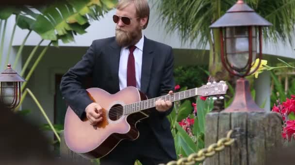 Barbudo hombre en traje negro toca la guitarra — Vídeos de Stock