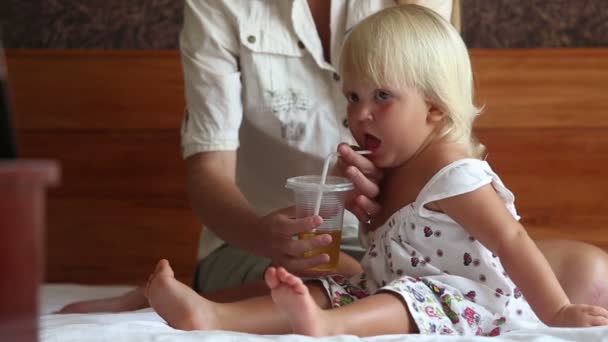 Small blonde girl drinks tea — Stock Video