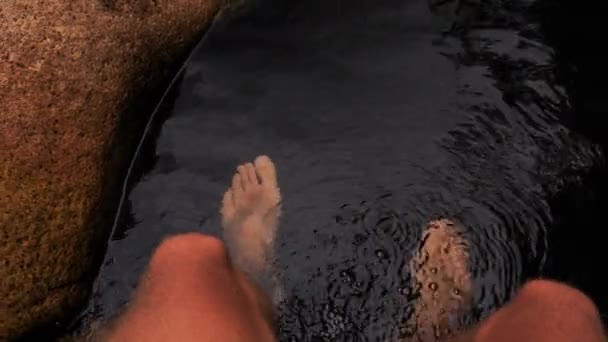 Caucasian guy washes feet in lake — Stock Video