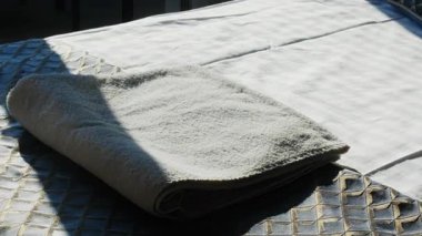 Erkek eli, sabah otel odasındaki yataktan temiz havlu alır. Erkek misafir, konukevinde lüks konukların hizmetinden hoşlanır.