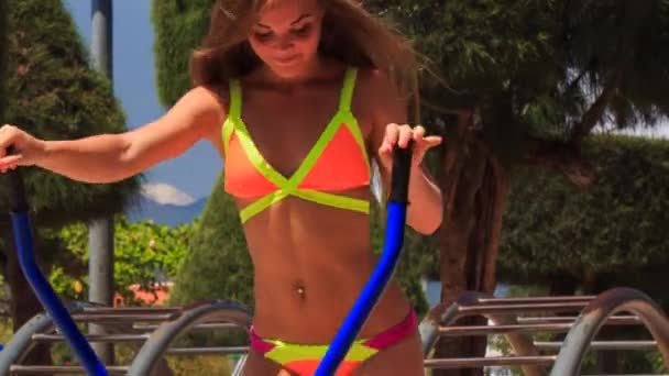 Girl in bikini trains on stepper — Stock Video