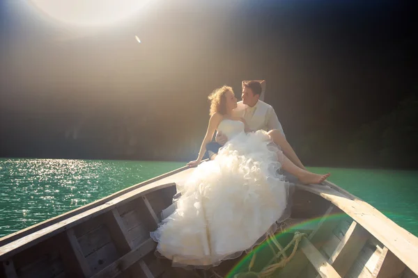 Groom and bride in fluffy on nose of longtail boat — Stock Photo, Image