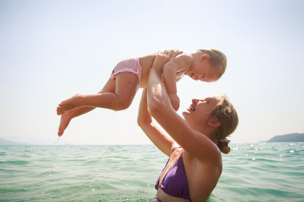 mother teaches swim  daughter