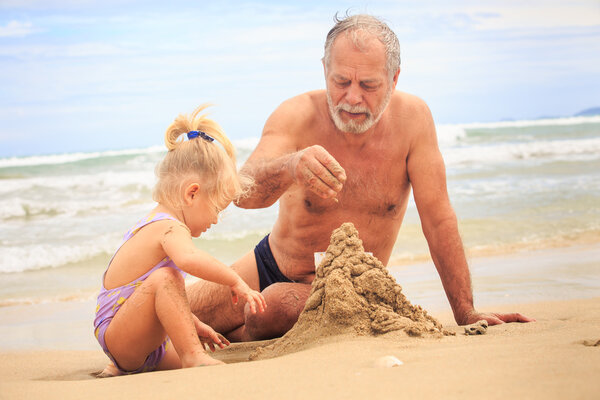 Grandpa  and children  Building Sand Castle