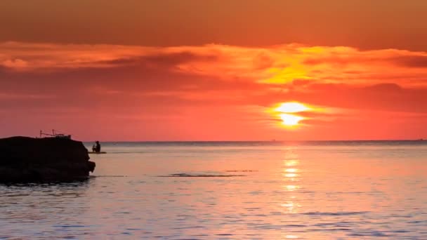 Fishing boats over red sunset sky — Stock Video