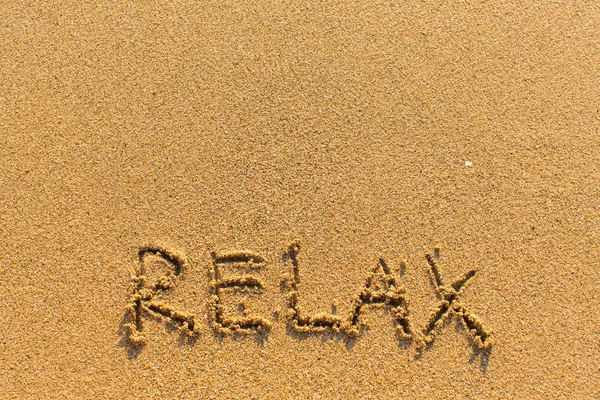 Relaxe - inscrição na areia — Fotografia de Stock