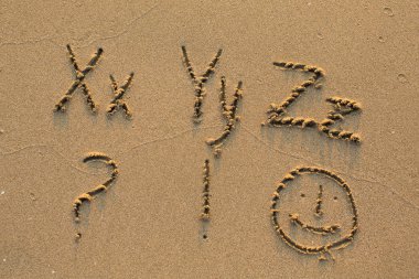 Alphabet written on beach sand