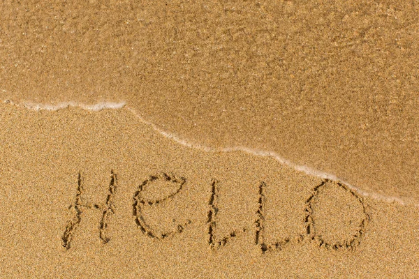 Hello - word drawn on the beach — Zdjęcie stockowe